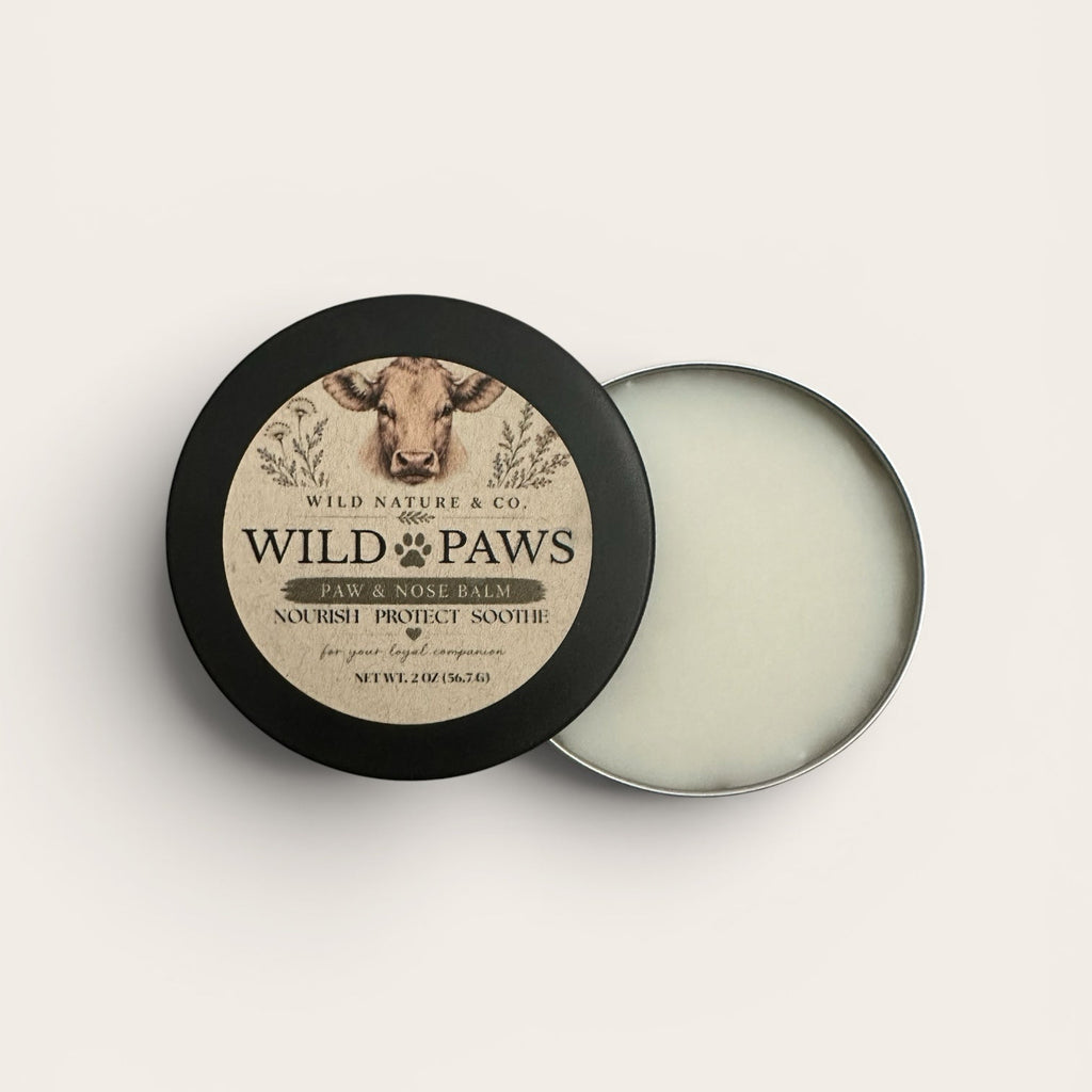 Wild Nature & Co. Wild Paws paw and nose balm in a black round tin with a natural cow illustration on the label.
