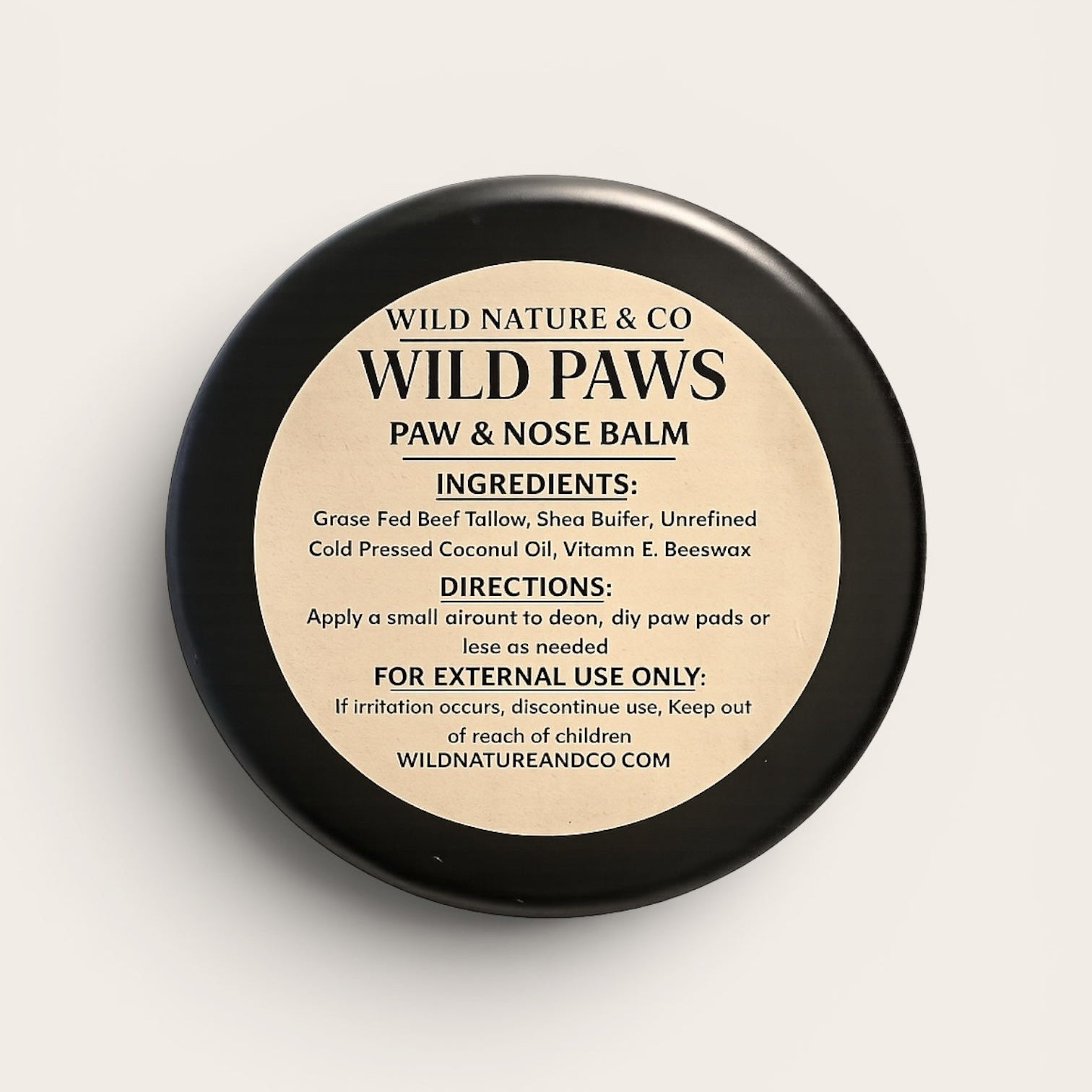 Wild Nature & Co. Wild Paws Paw and Nose Balm in a black circular tin with a cream label on a light background.